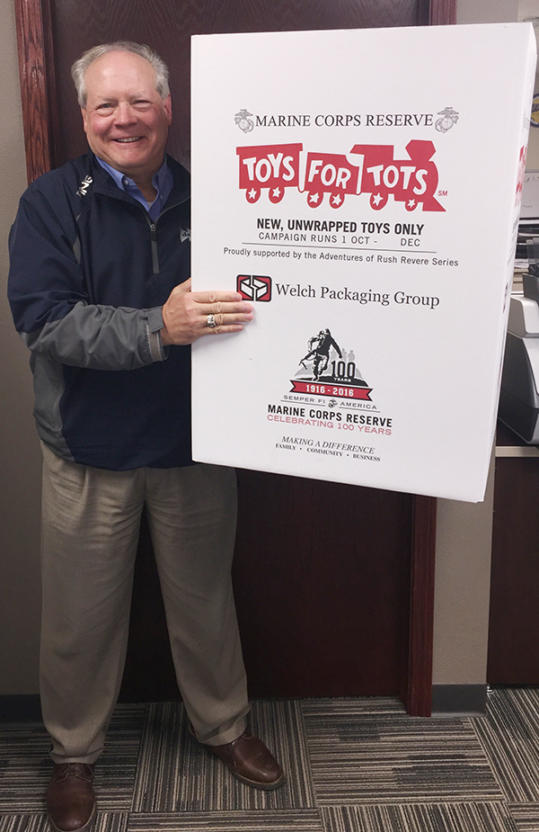 Dalton employee holds sign showing donation to Toys for Tots